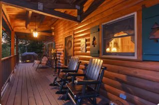 Cozy cabin porch with rocking chairs at dusk